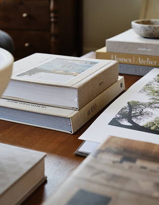 several stacks of books on a desk