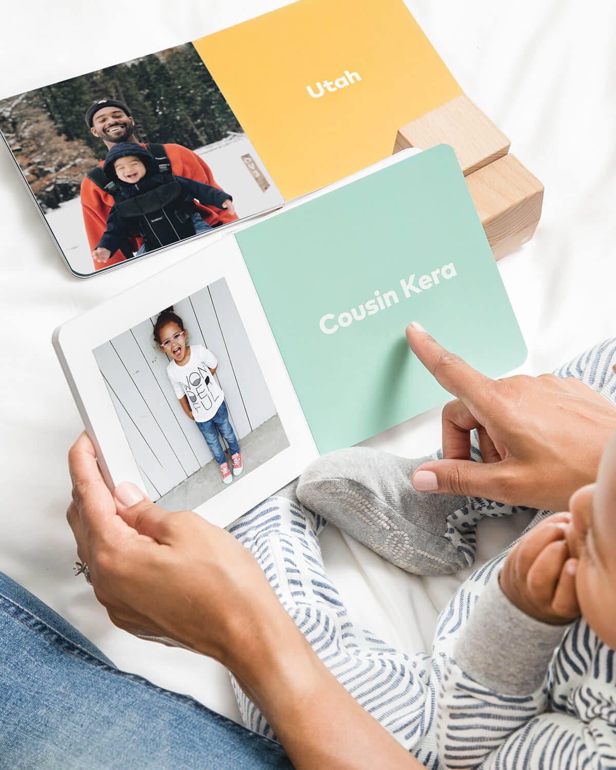 mother reading baby board book to child