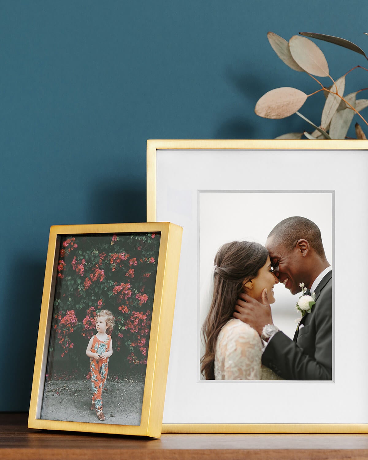 metal frames standing on mantel with photo of couple and child