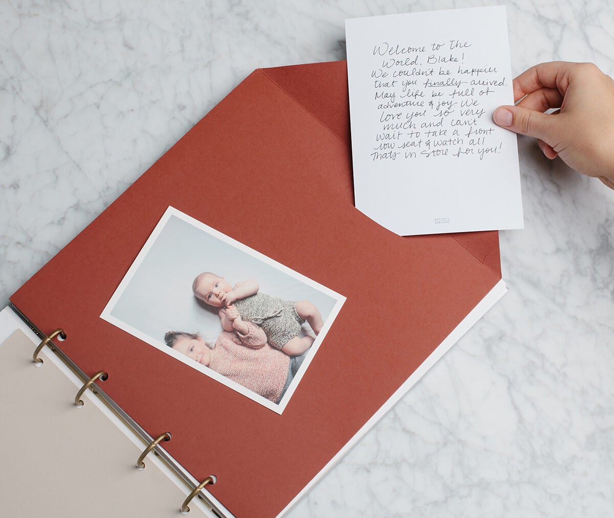 Artifact Uprising Story of You Baby Book being used as a guest book for baby's first birthday