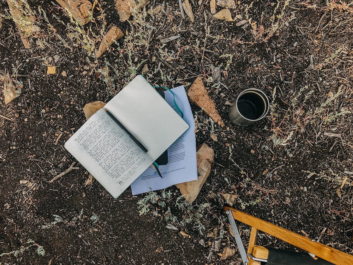 Open journal in campsite with notes written