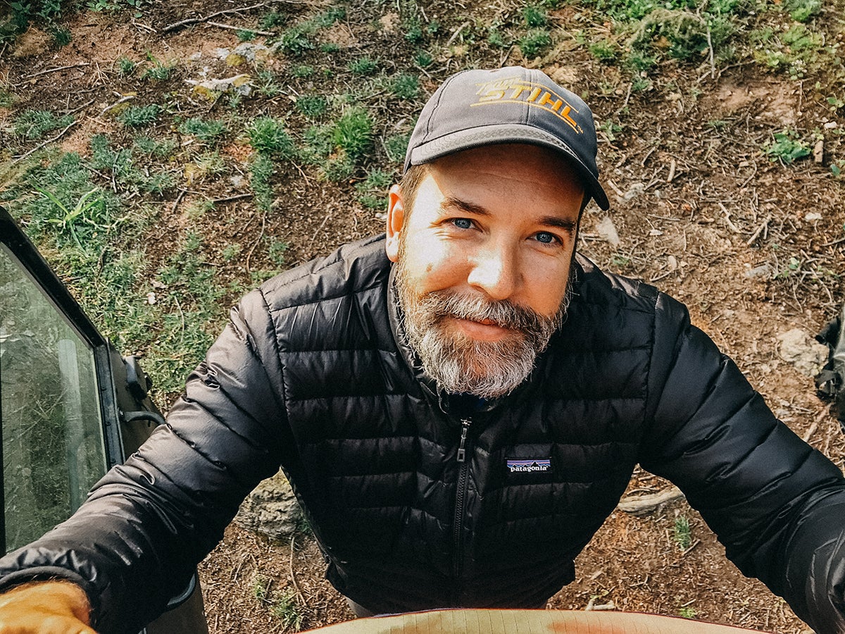 man in outdoors staring up at camera