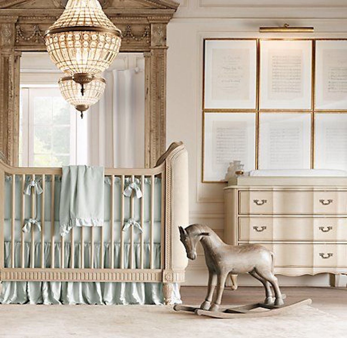Gallery wall, crib, and rocking horse in nursery room