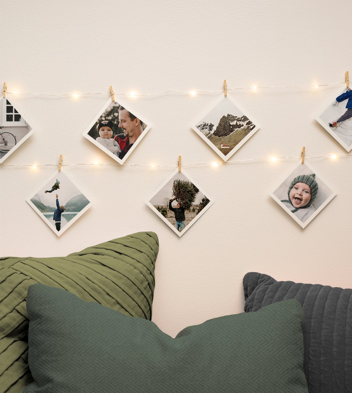 Family photos strung up on the wall using holiday lights