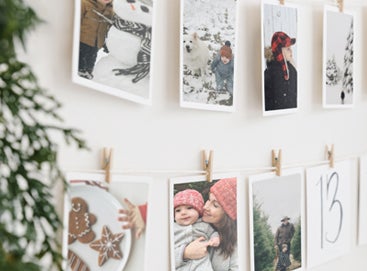 A holiday advent calendar created with prints hung from a line