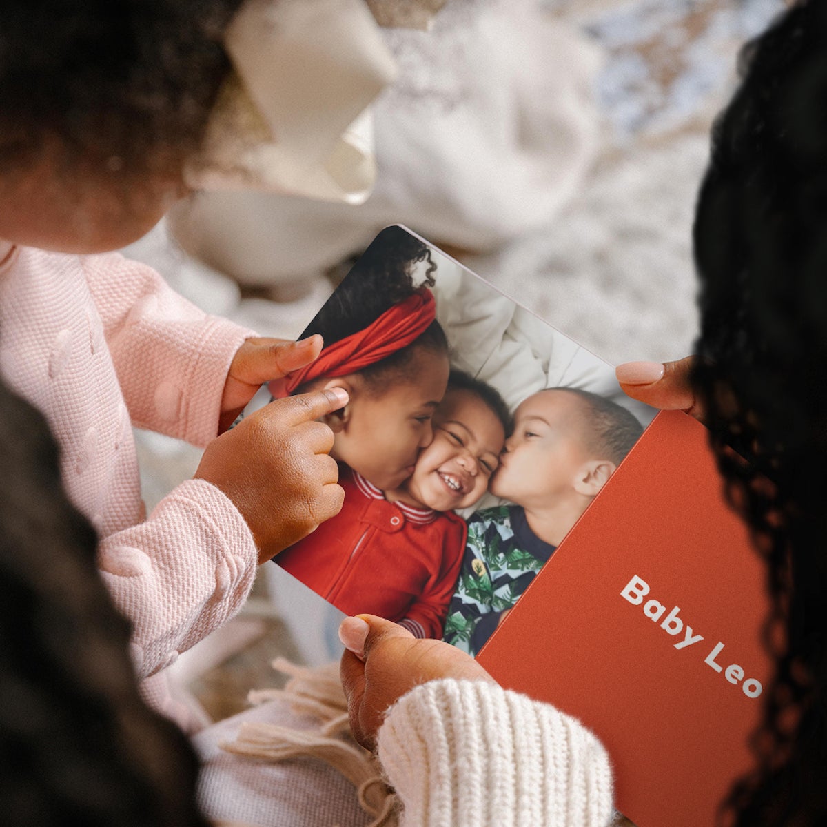 Mother reading family-themed baby board book with daughter