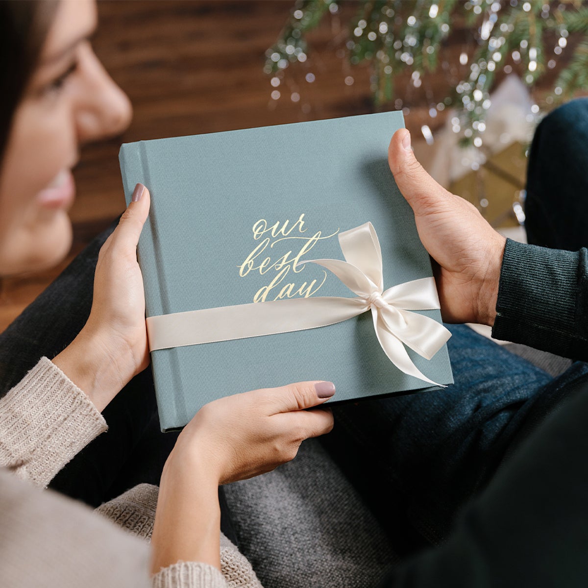 Woman gifting Wedding Layflat Album to husband