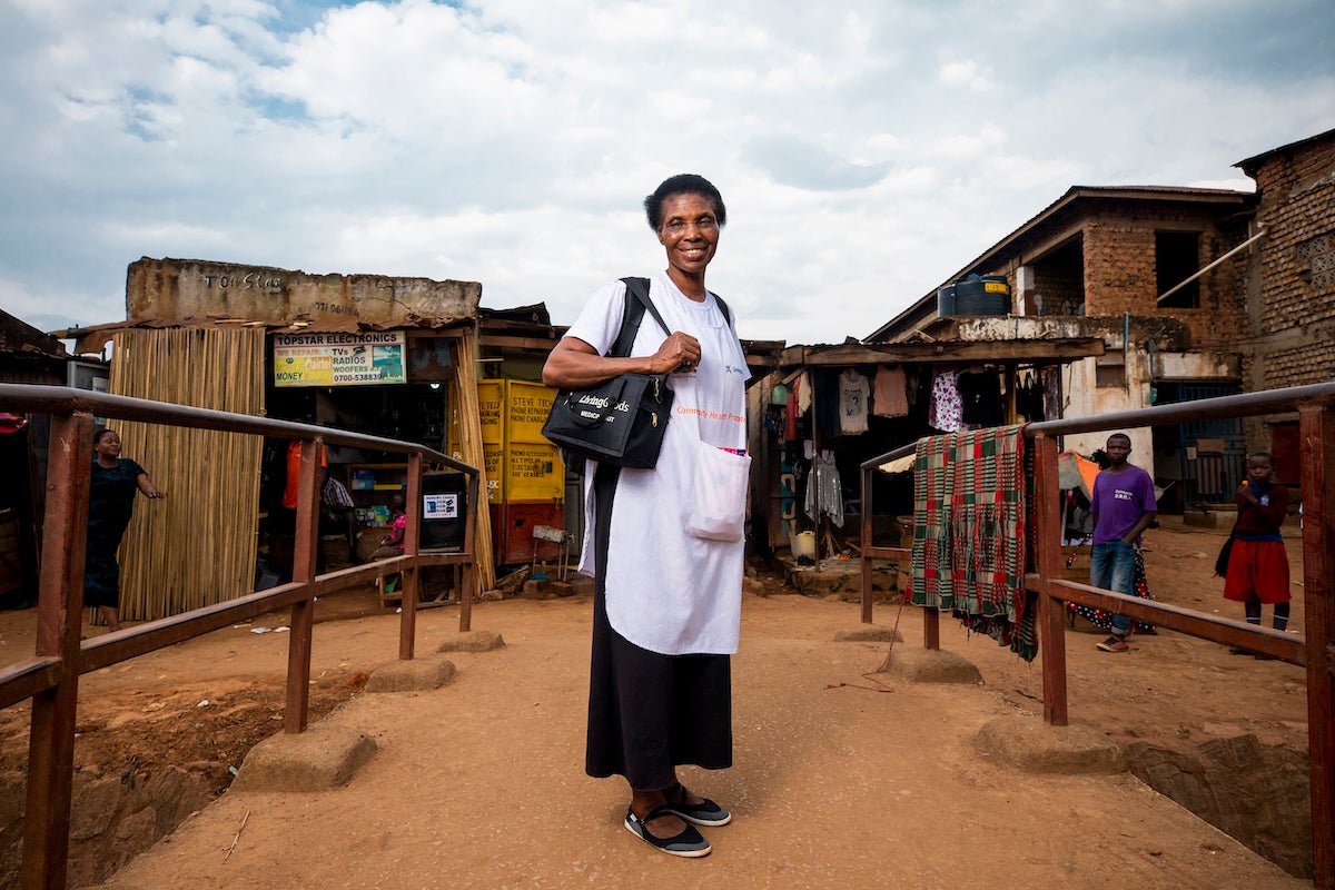 Joy stands on the same bridge in the summer of 2019 after it has been rebuilt by the government