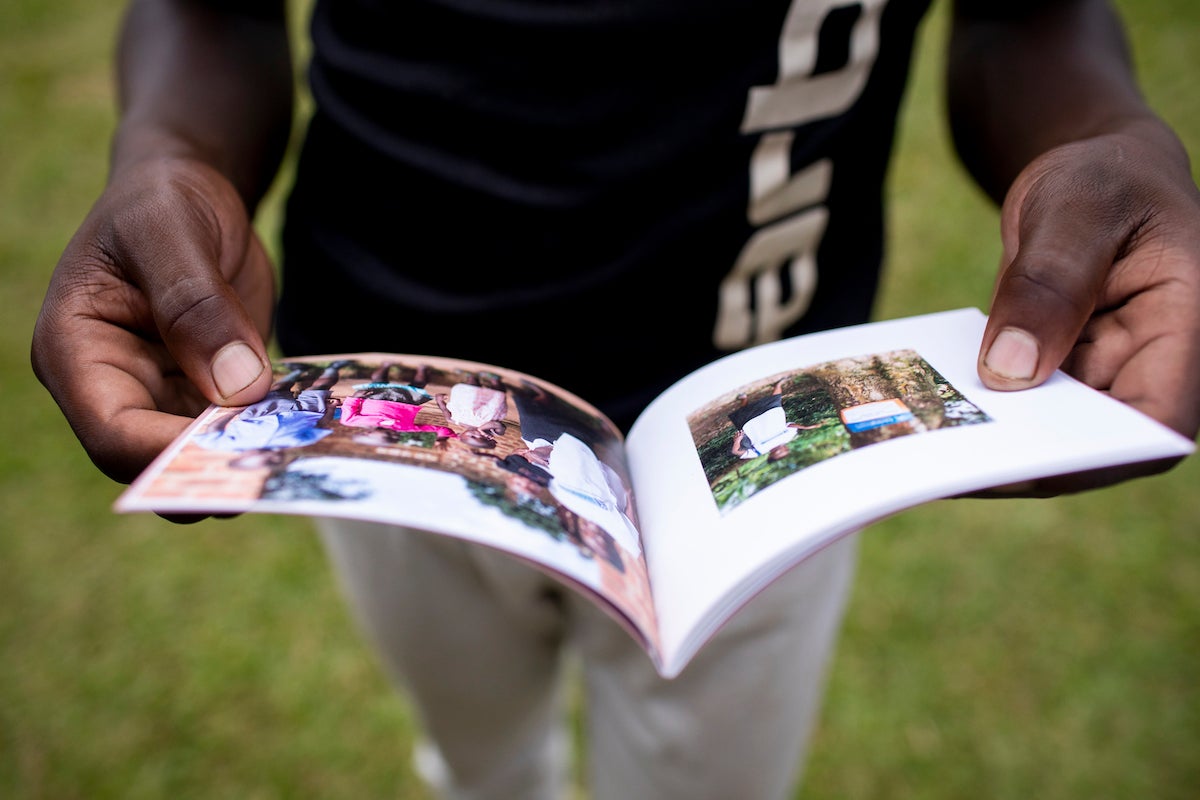 Close up of photo book in a man's hands