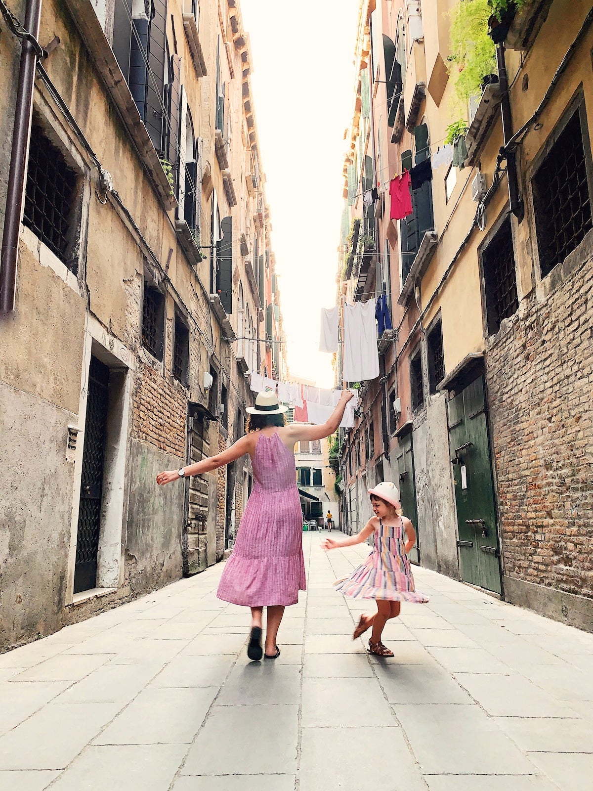 A mother and daughter dance in the streets of Italy