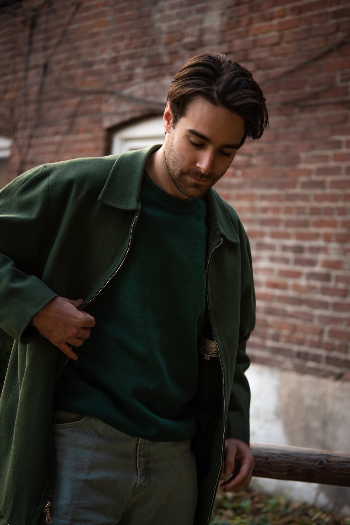 Young man in green jacket outside