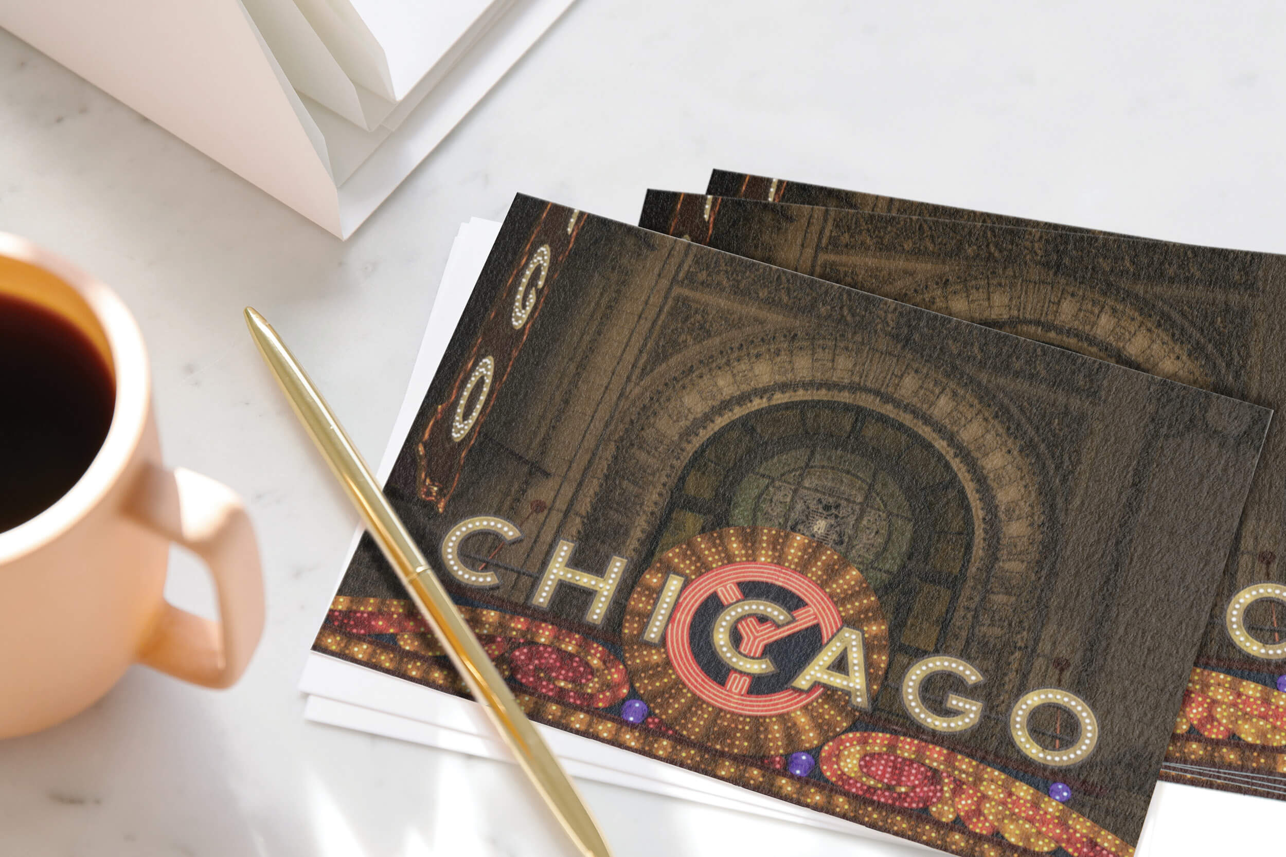 Pen resting on stack of Chicago postcards