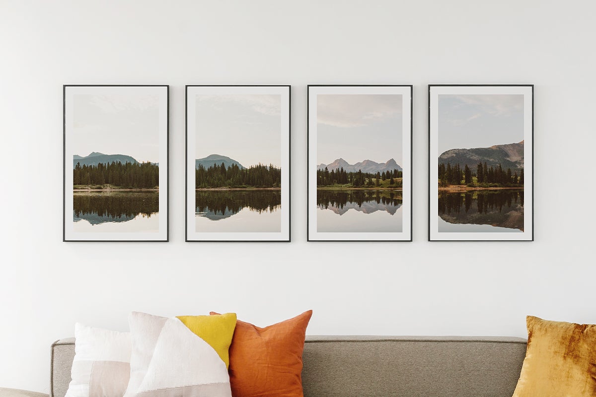 Panoramic photo of mountain landscape split evenly between four frames on the wall