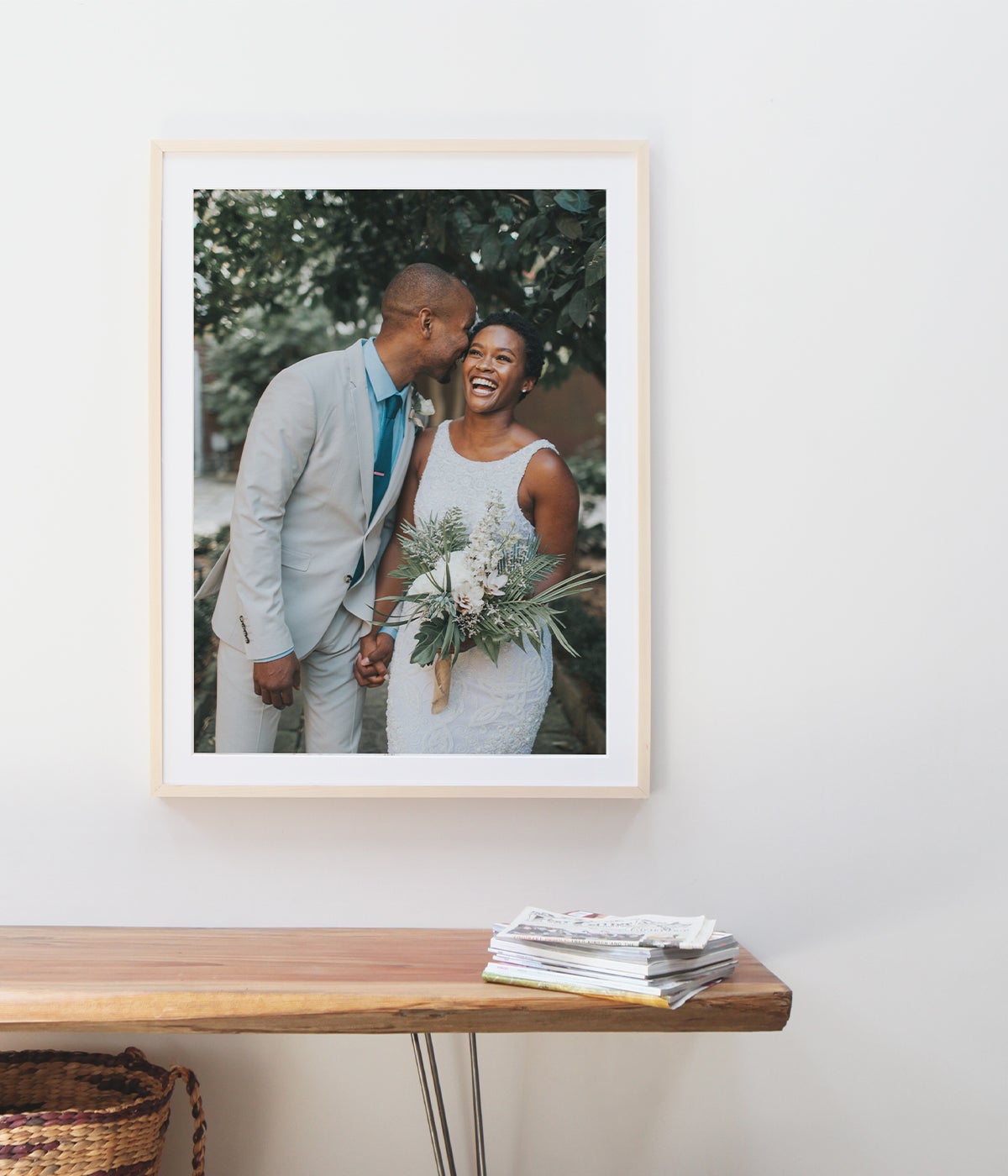 Large framed wedding print of young couple above wood bench