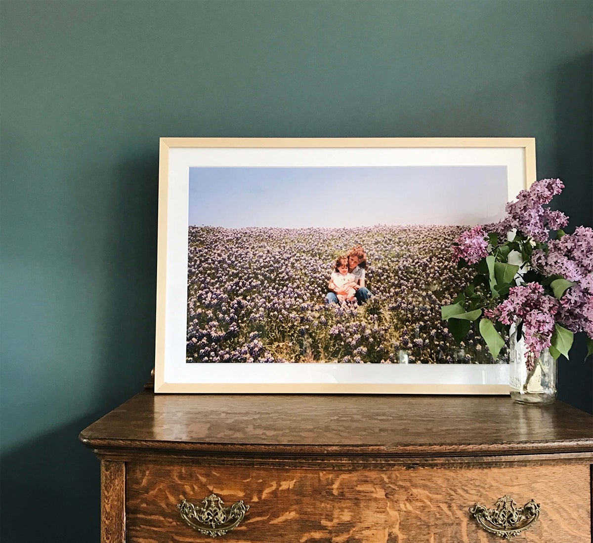 Gallery frame with vintage mother and daughter photo resting on dresser
