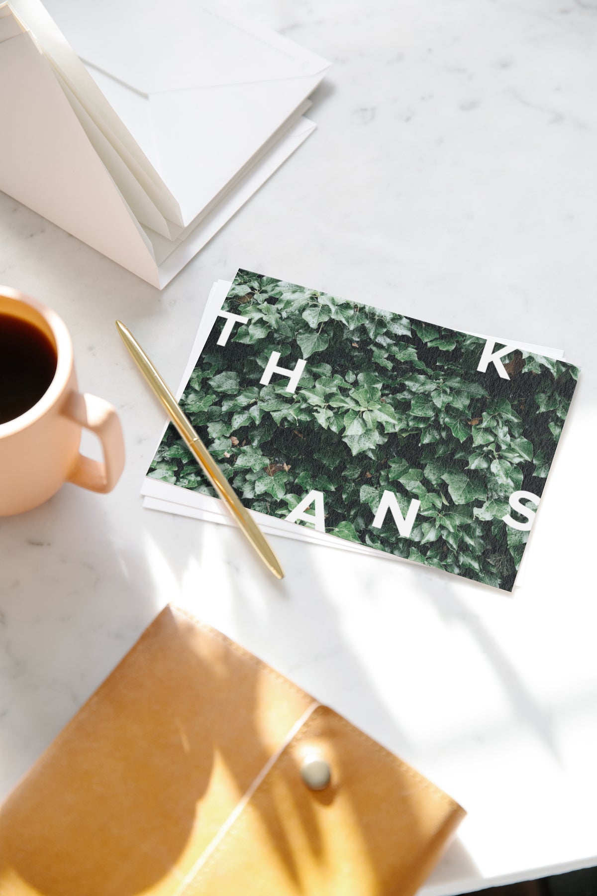 Thank you card sitting next to cup of coffee
