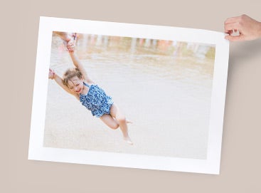 Large format print of little girl playing in water