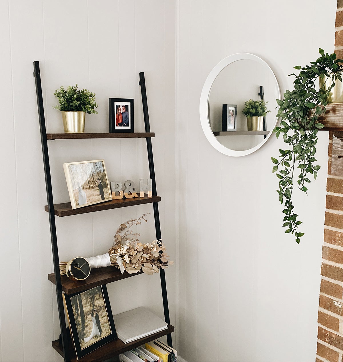 Photo by Brian Schindler of shelving display with photos frames and small plants