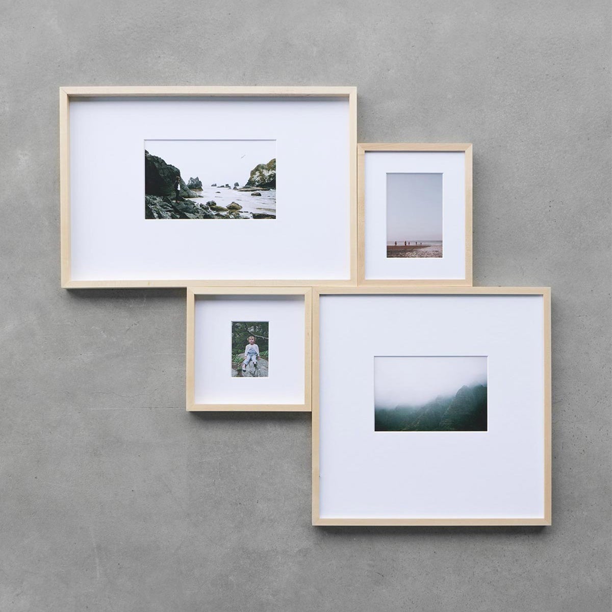 Small gallery wall of matted frames with no space between them