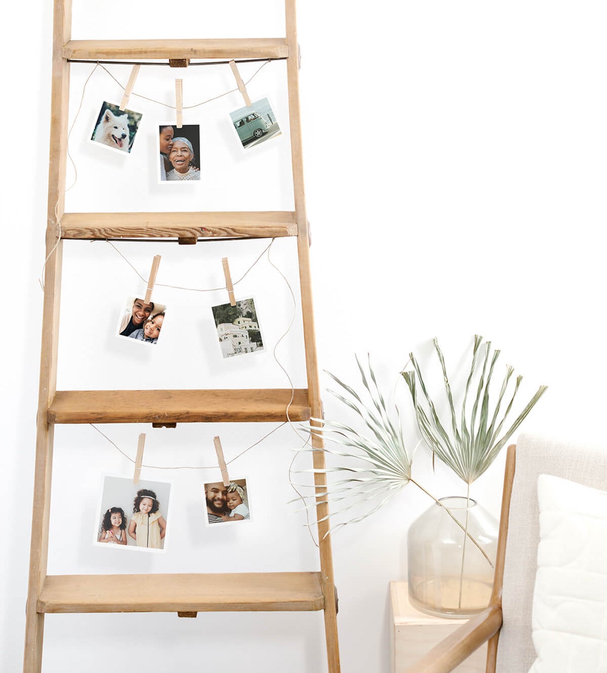 Wooden ladder repurposed to display photo prints