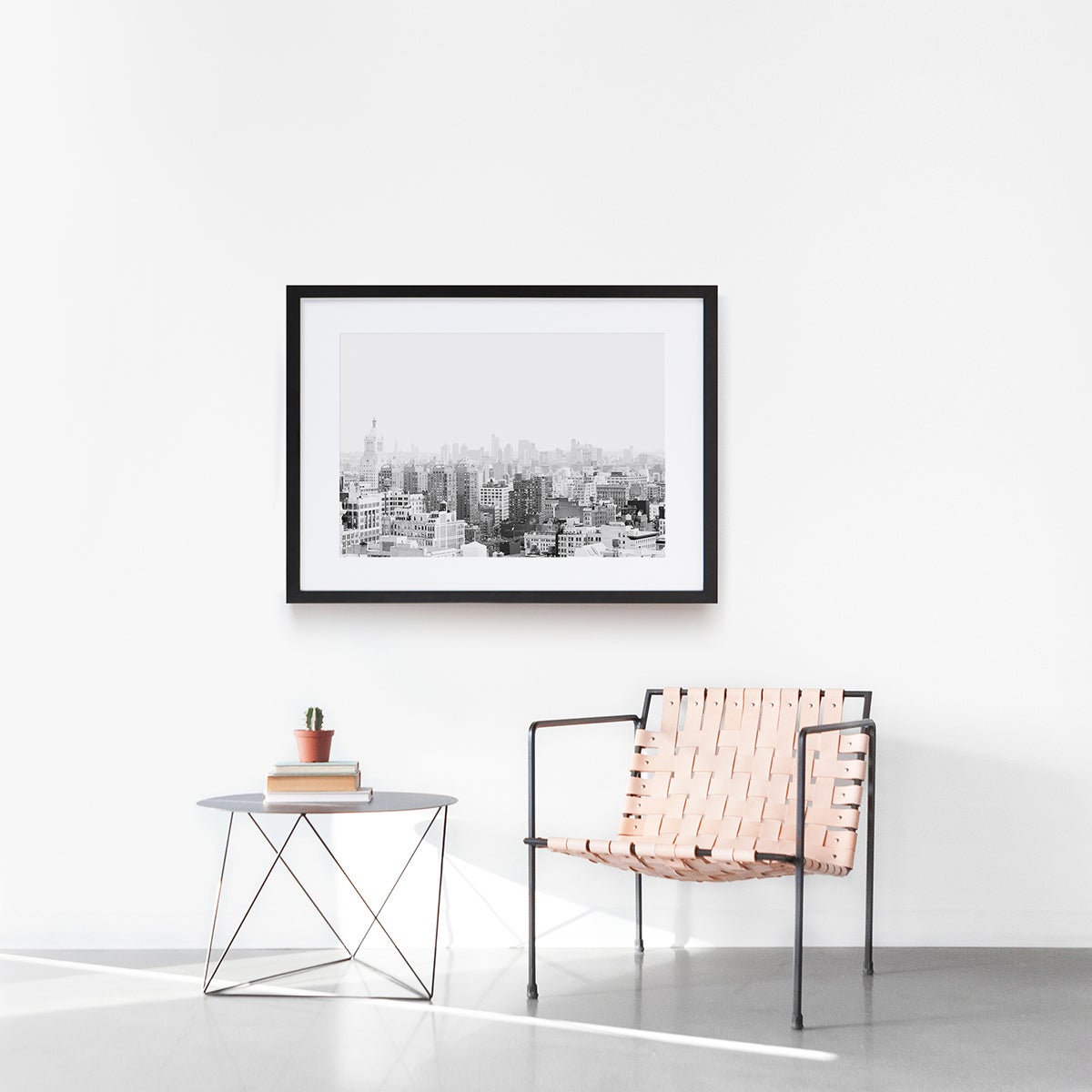 Minimalist interior design scene with chair, sidetable, and frame