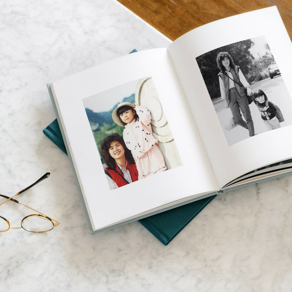 Hardcover photo book opened to photos of mom with daughter