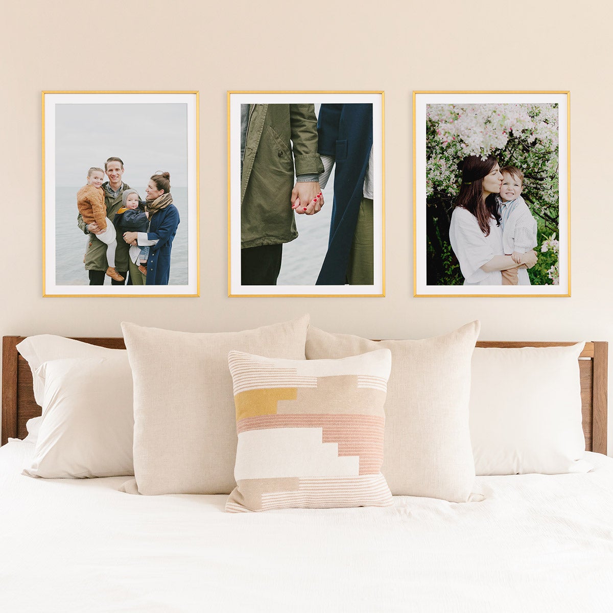 Series of framed family photos above bed