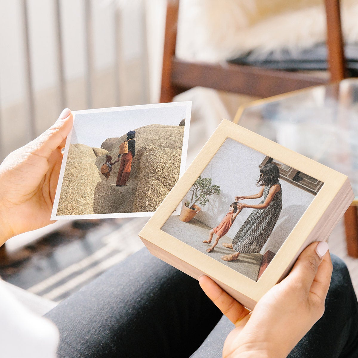 Hands putting new feature photo into Brass & Wood Display Box