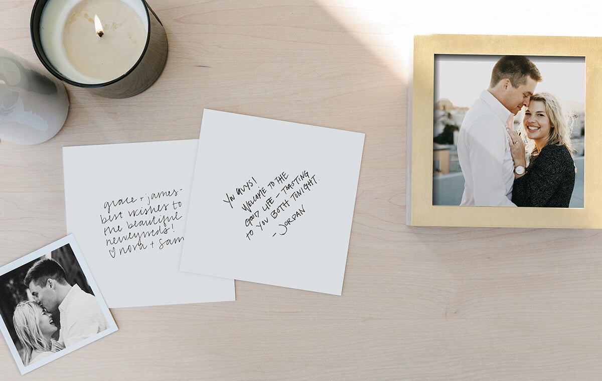 notes from wedding guests on the back of photo prints