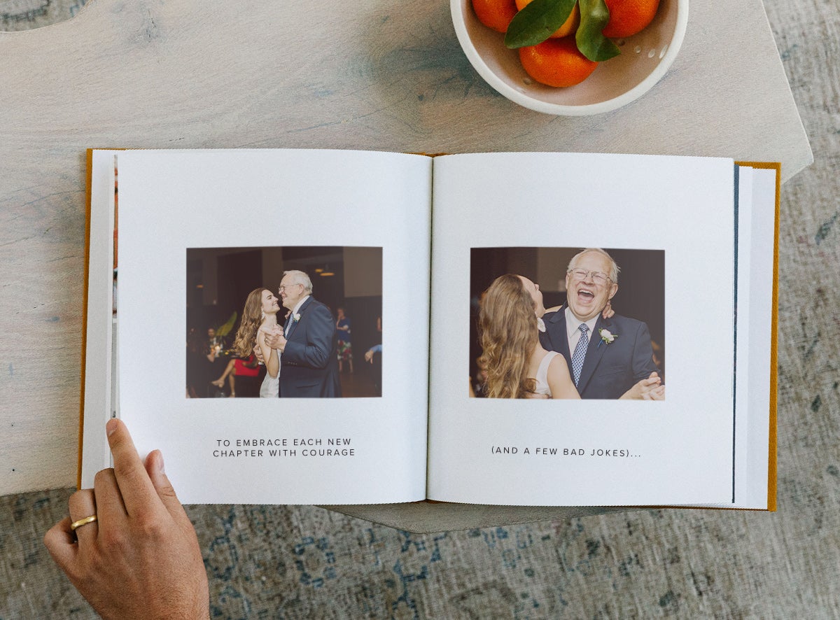 Photo book opened to photos of father and child with captions underneath images