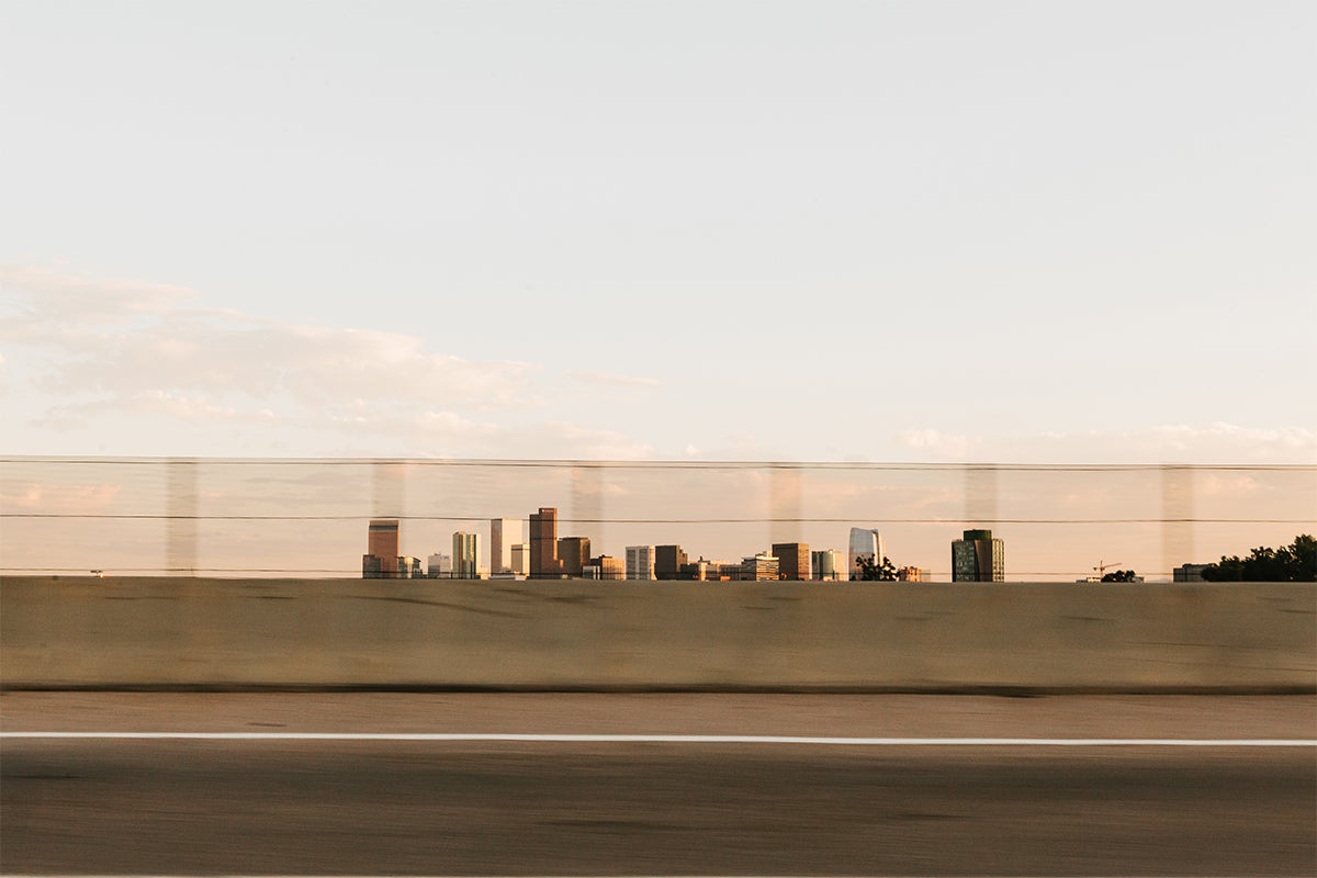 Blurry photo of Denver skyline taken from moving car