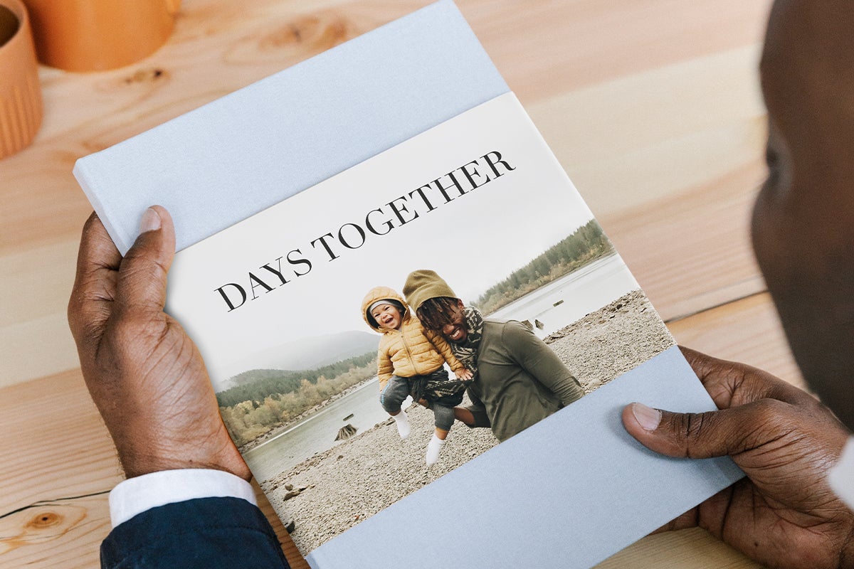 Father and son on cover of family photo album titled days together