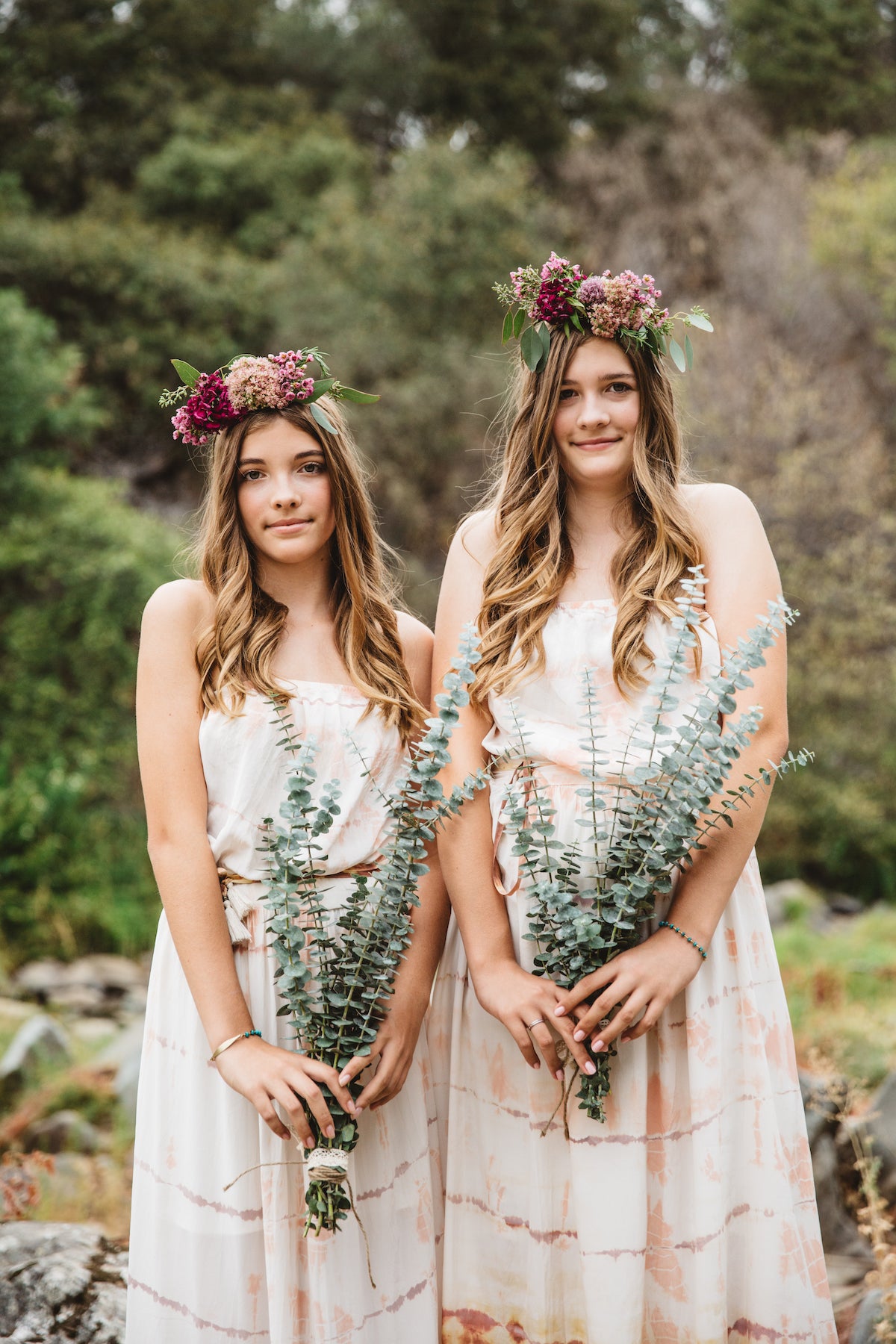 Flower girls in flower crowns holding bouquets