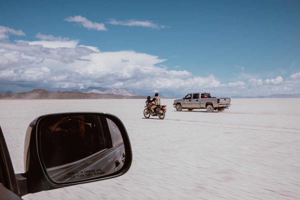 Groom riding motorcycle through the desert