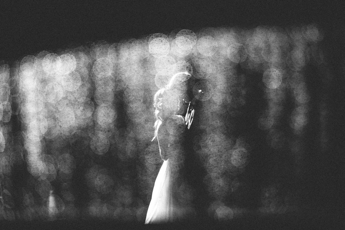 Black and white photo of bride and groom taken through filter