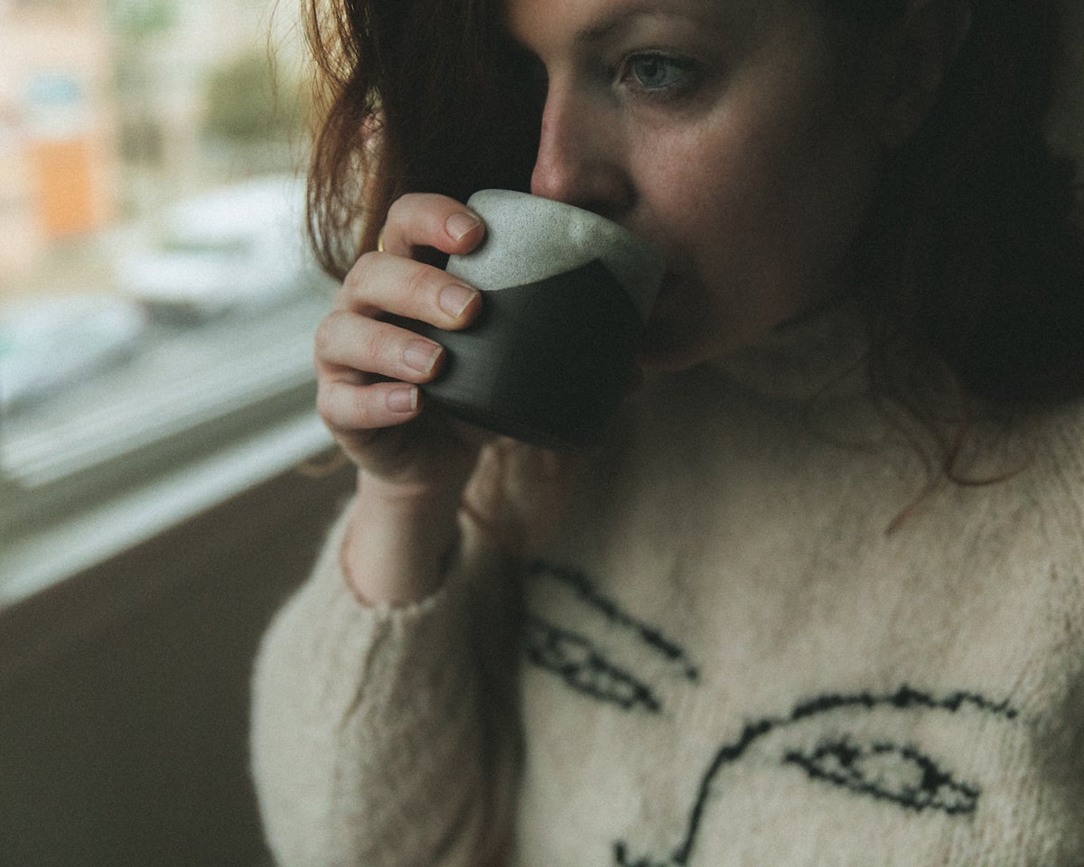 Self-portrait of Ashley Kelemen sipping coffee
