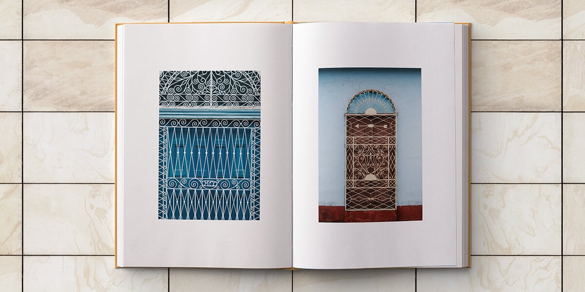 Cuba photo album opened to photos of Cuban architectural elements