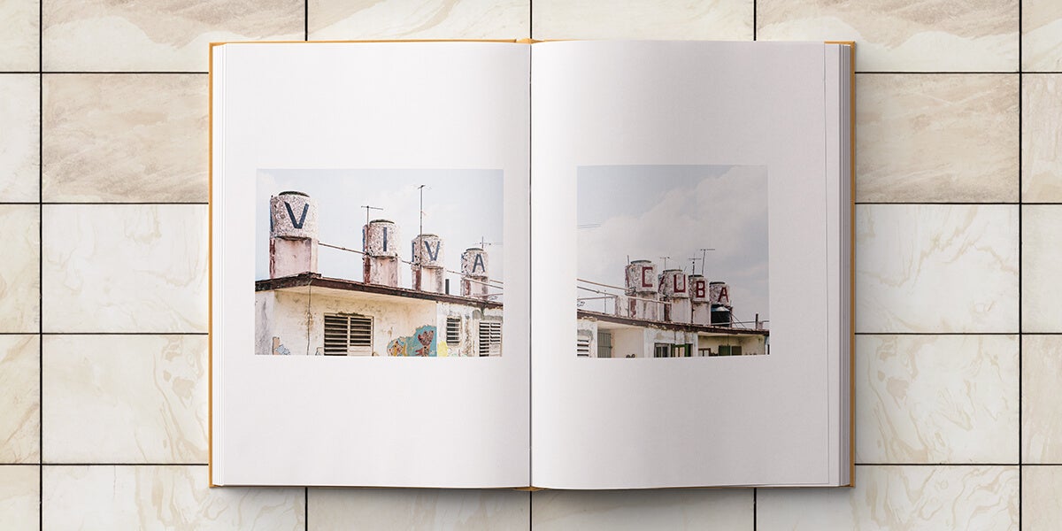 Cuba photo album opened up to panoramic photo split into two photos