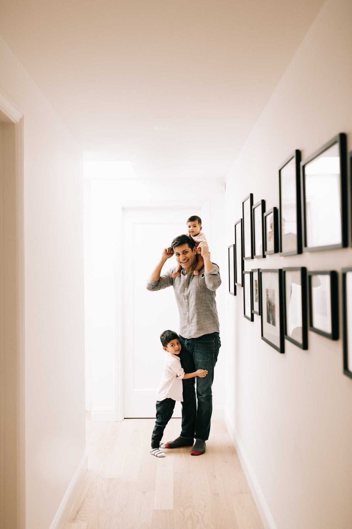 Father with children in brightly lit hallway