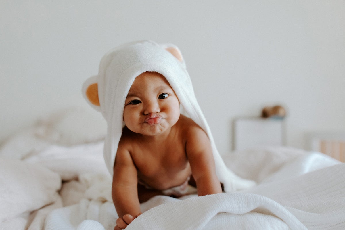 Baby crawling on bed after bath time