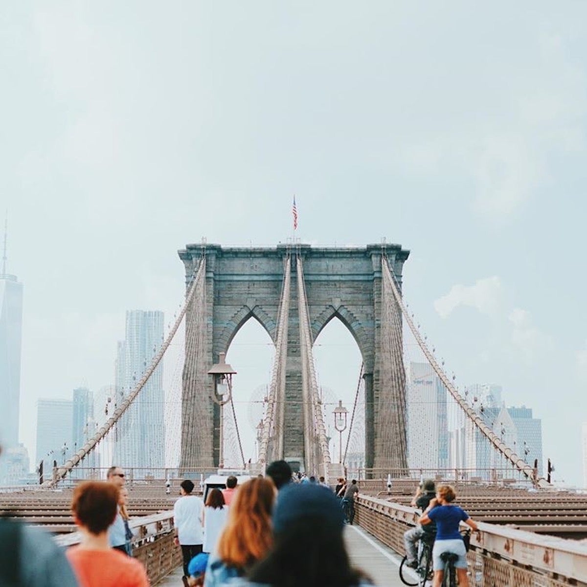 A shot of the Brooklyn Bridge showcasing the walkway with walkers and bike riders