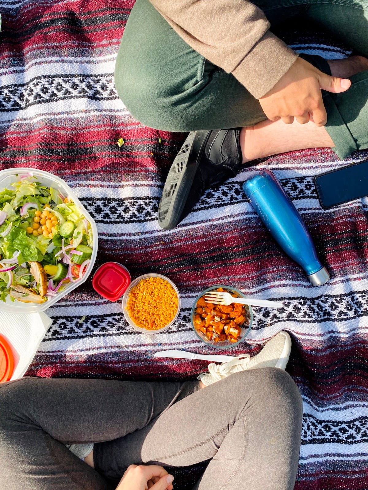 A meal laid out on a picnic blanket