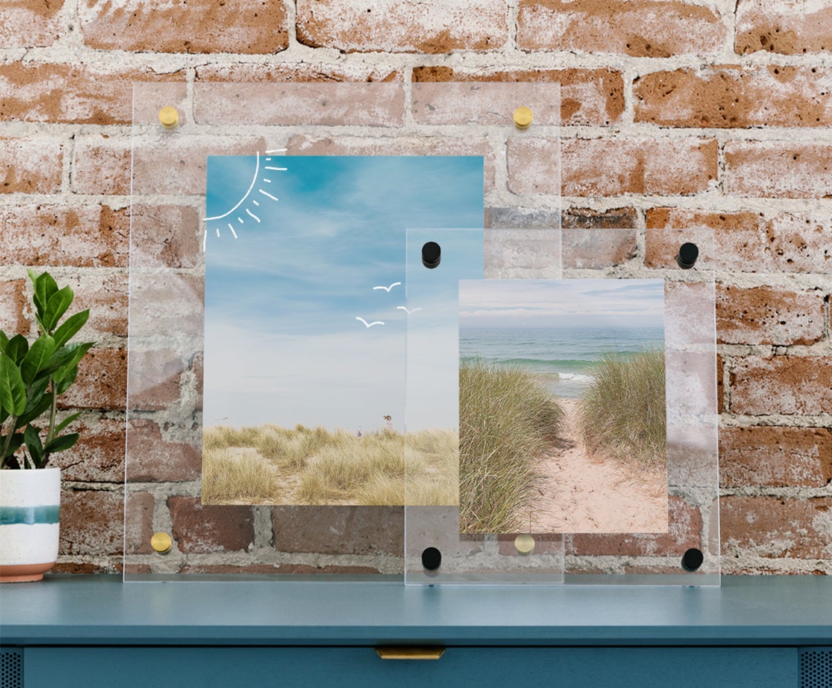Images in floating frames drawn on in marker by kids
