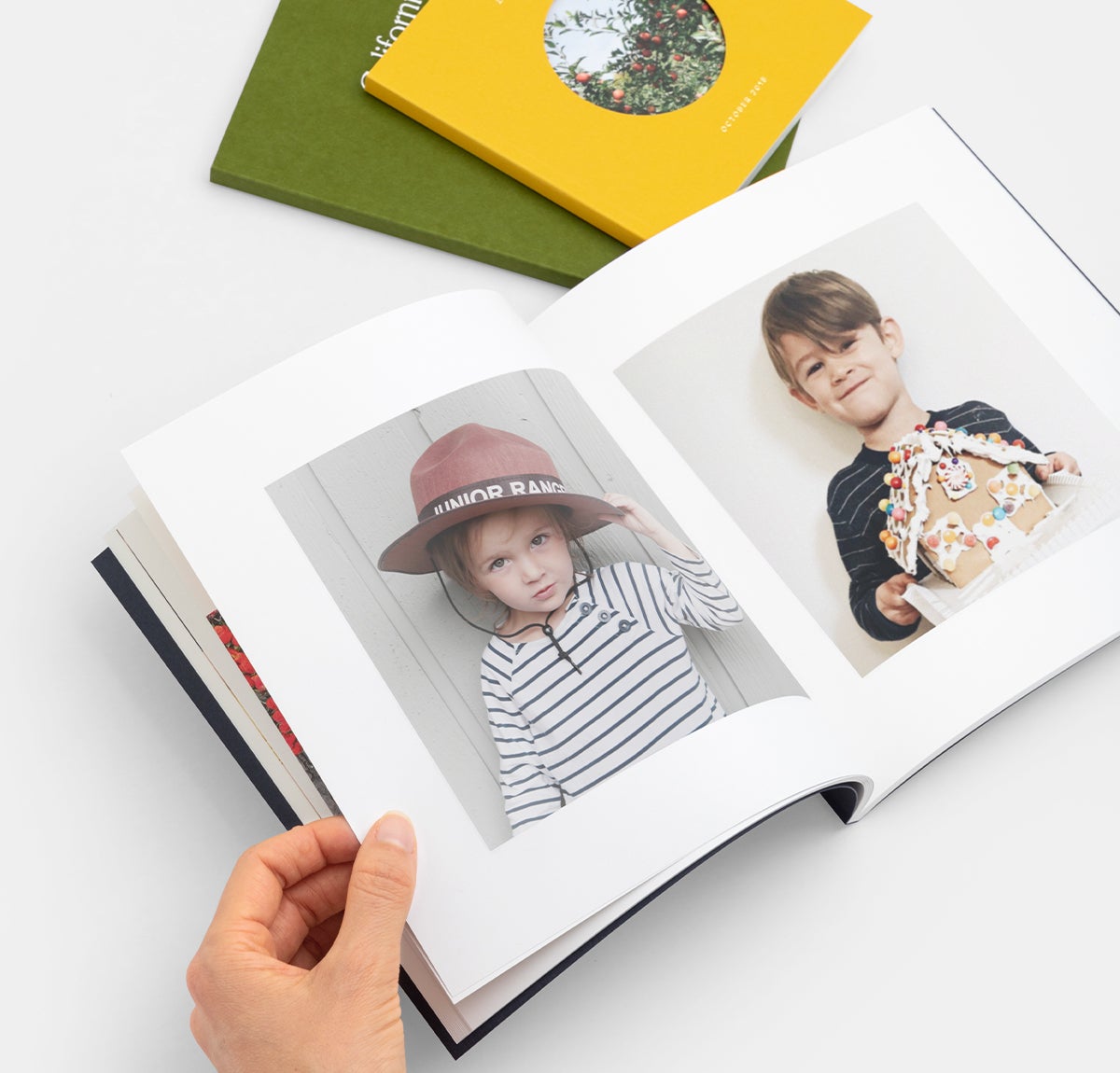 Photo books opened to portraits of two little boys