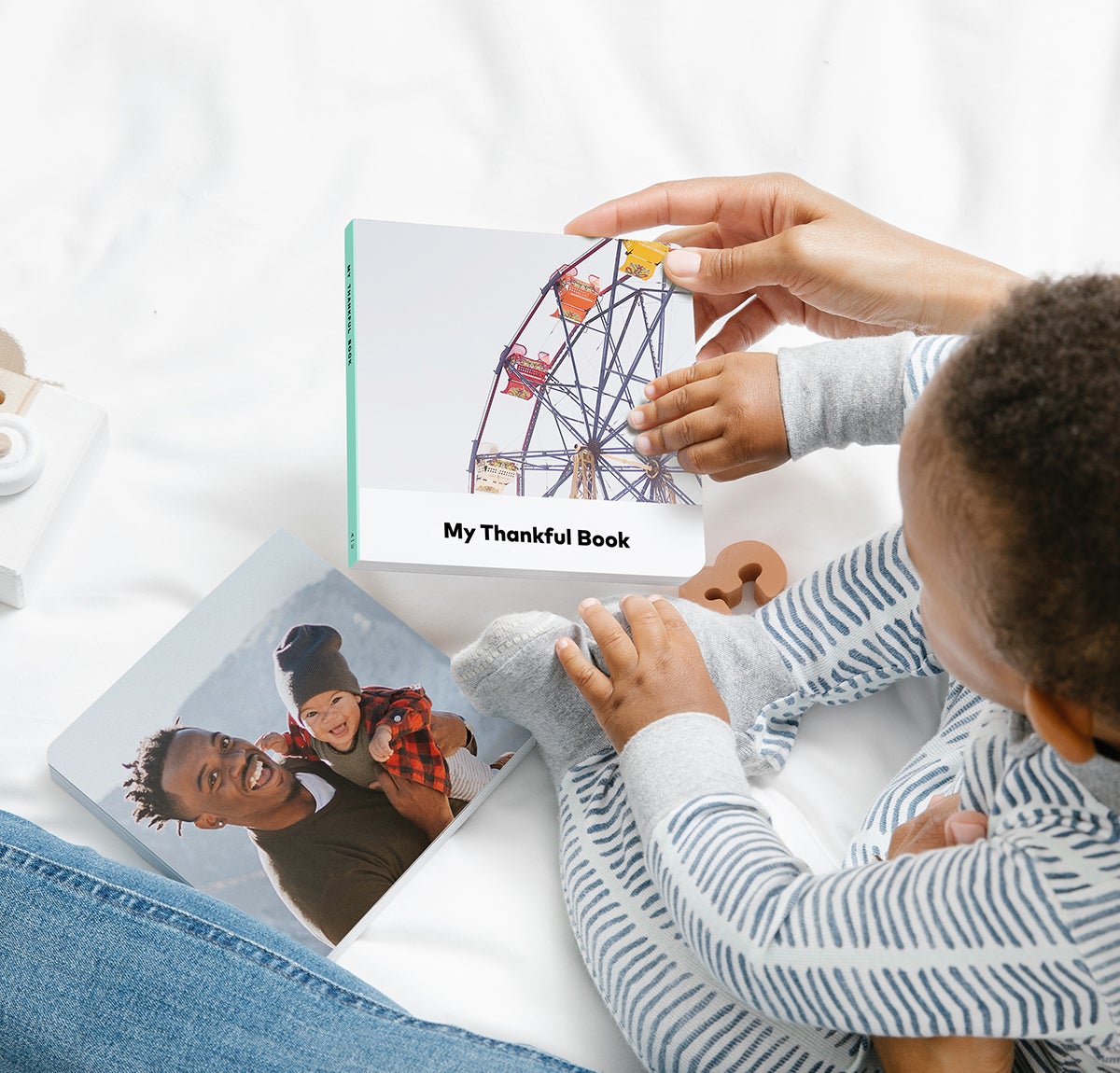 Little one holding board book titled My Thankful Book