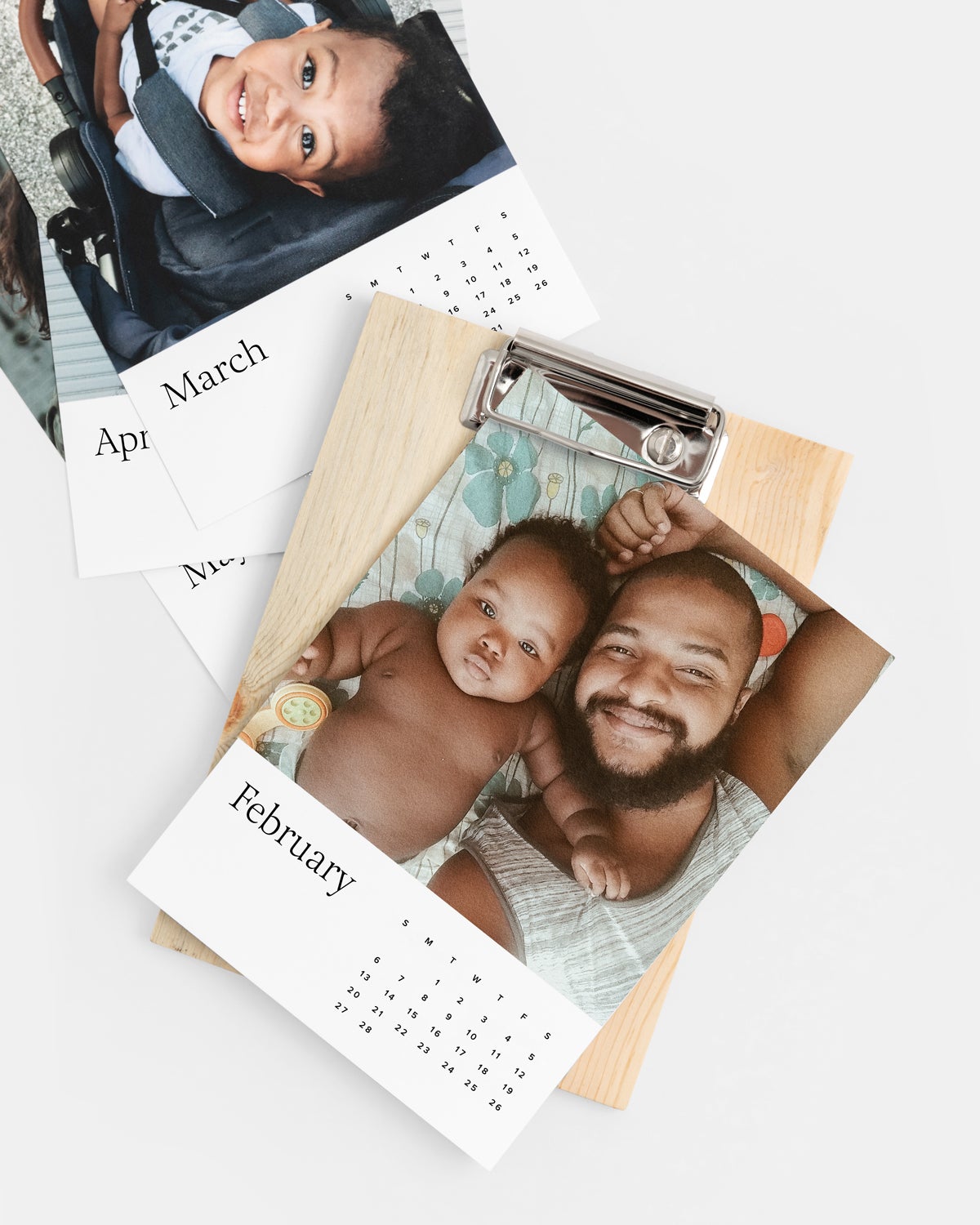 Desktop calendar featuring photo of father and baby laying down