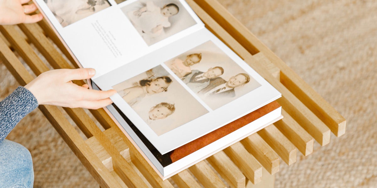 Woman flipping through pages of family history album
