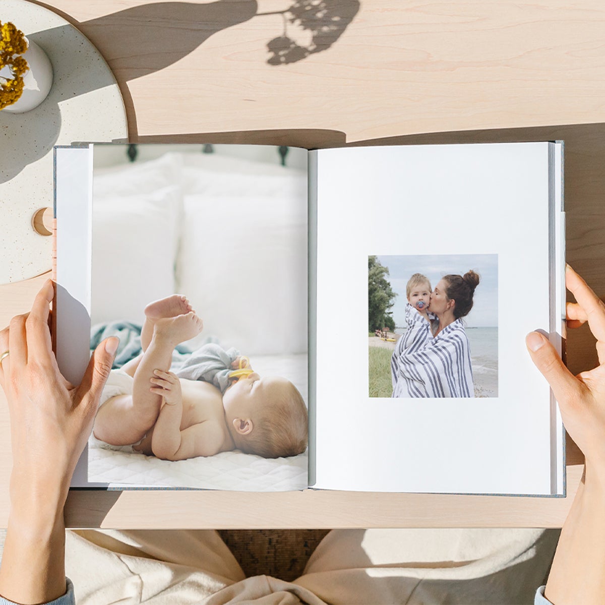 Interior of hardcover photo books showing two different layouts featuring baby photos