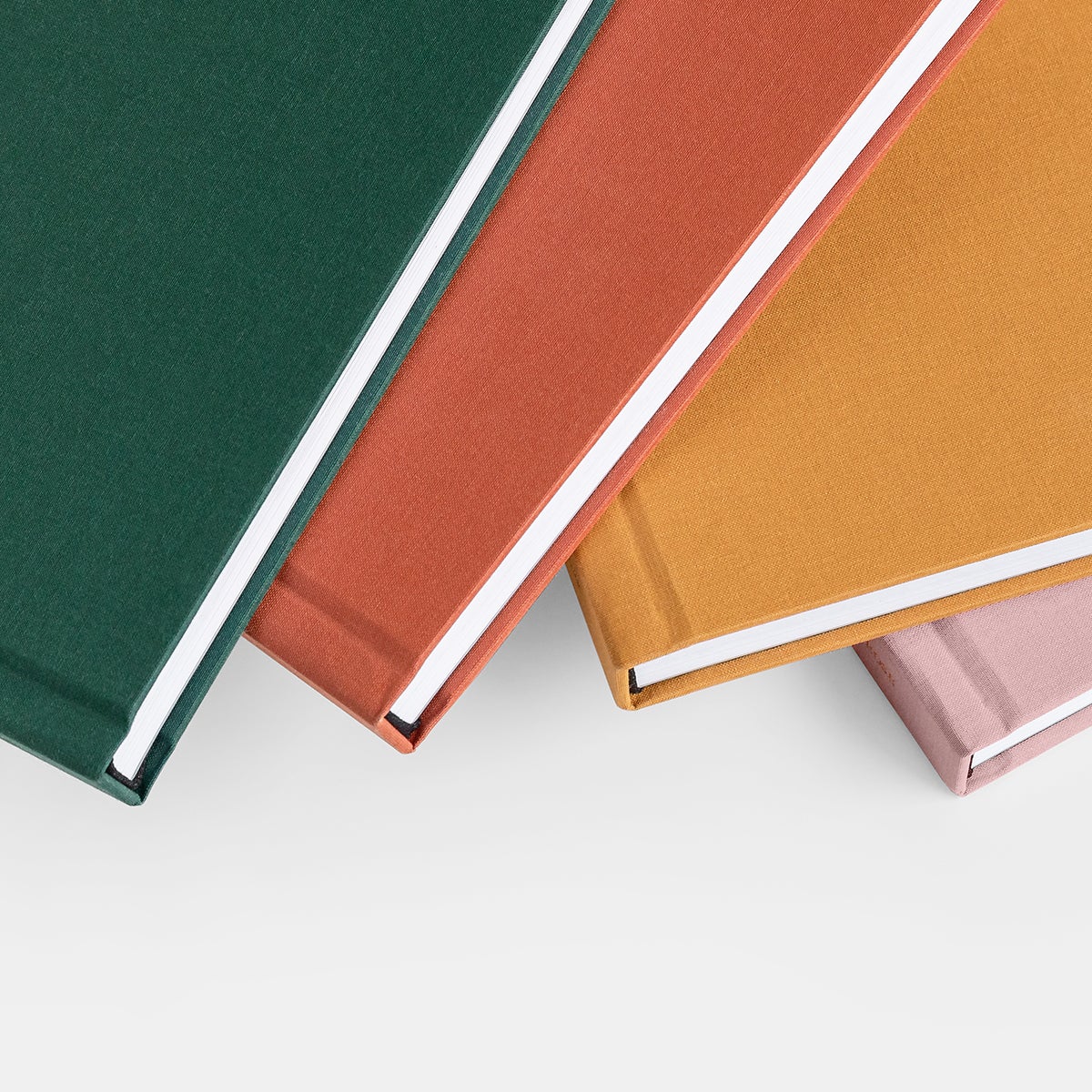 Close up of Layflat photo album’s linen cover in four different colors