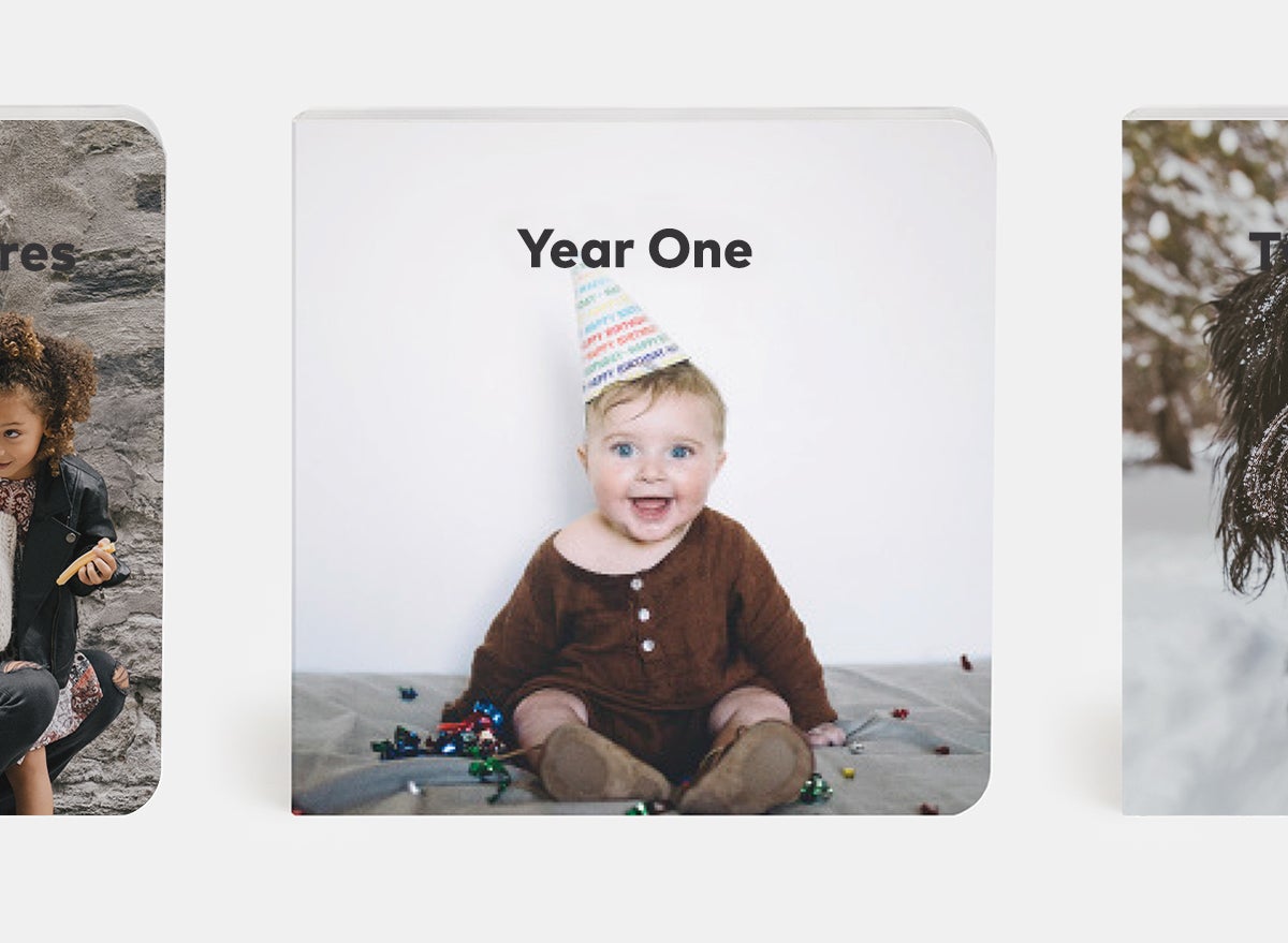 Custom baby board book titled year one featuring baby in birthday hat